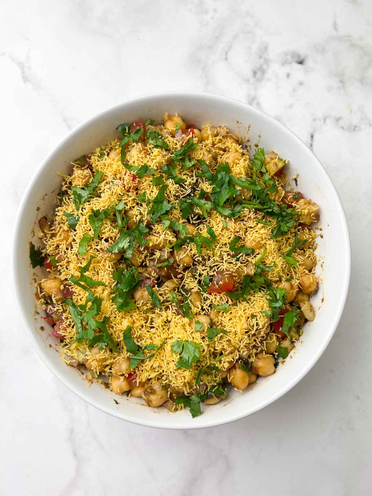 appetizer served in a bowl garnished with sev and coriander leaves