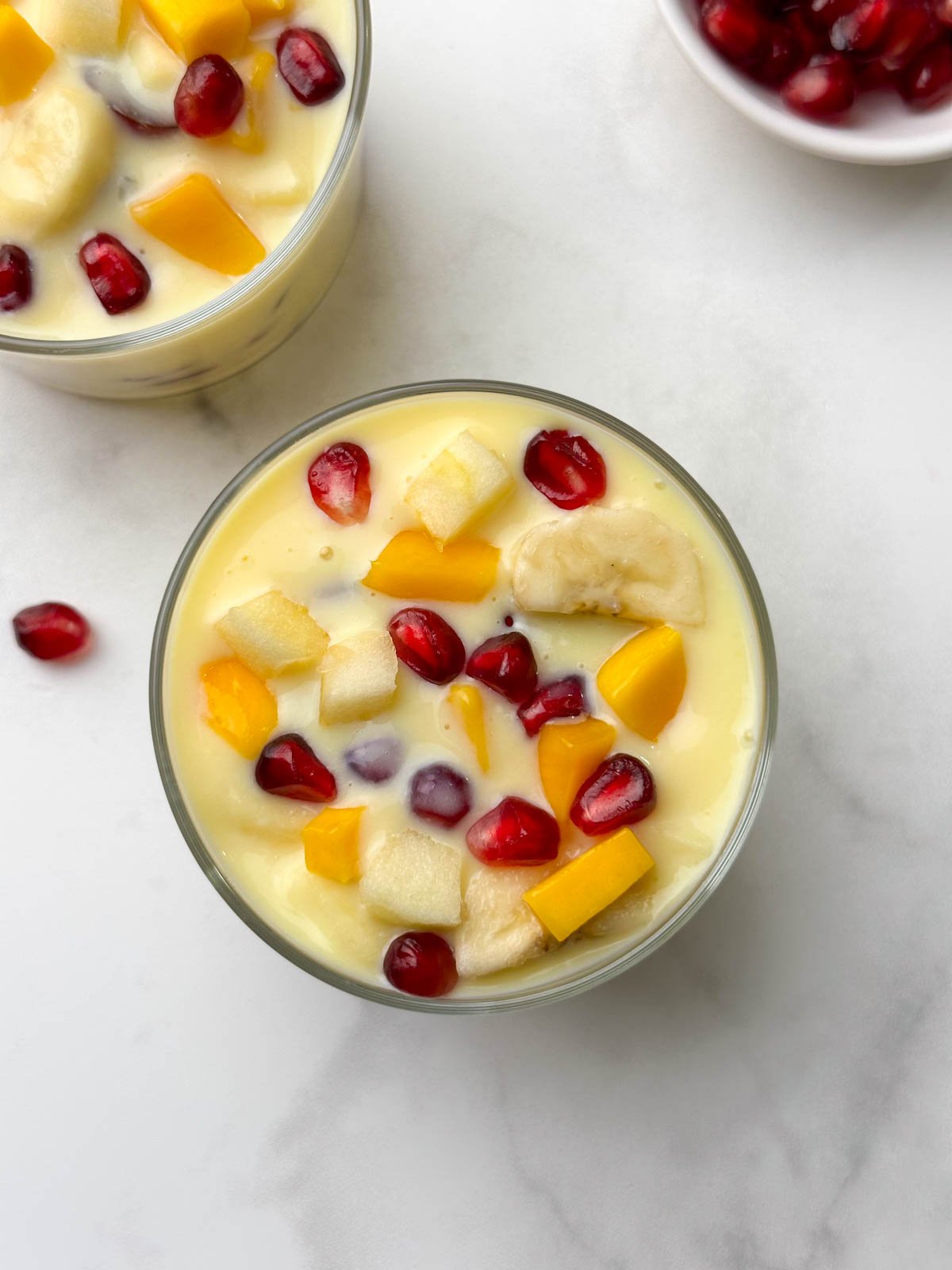 dessert served in 2 glass bowls with a spoon