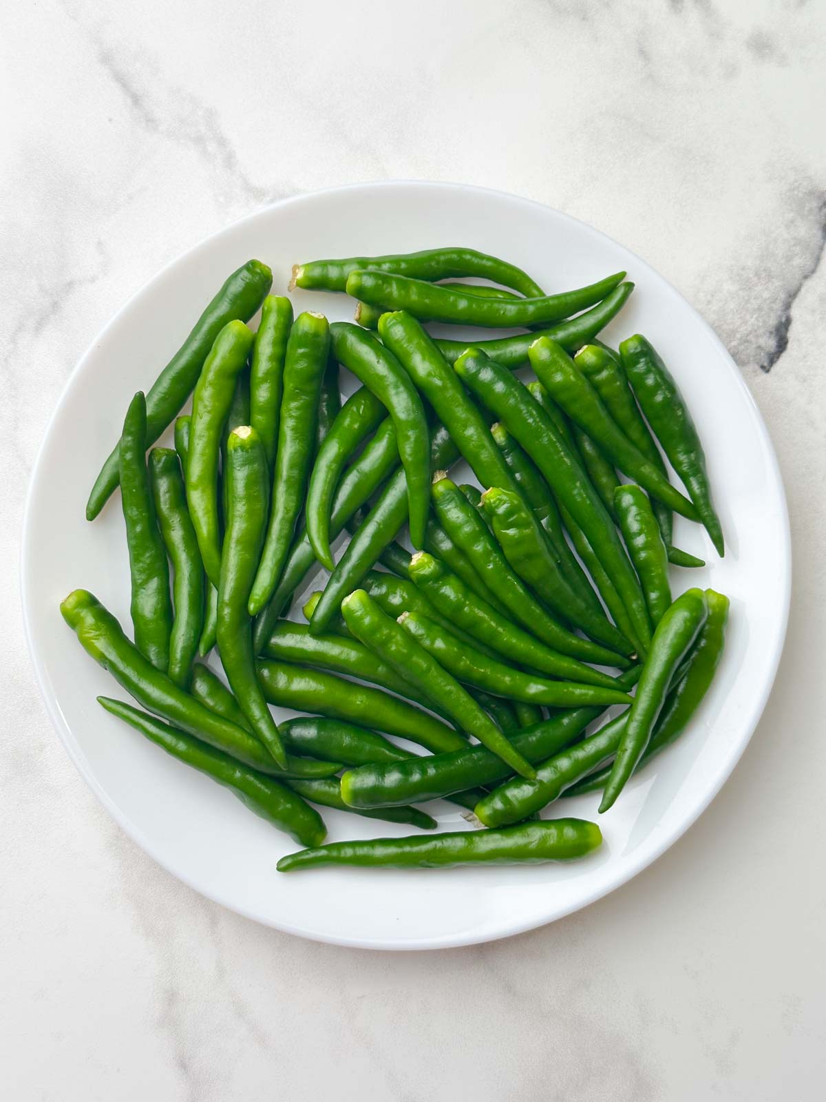 de-stemmed green peppers on a plate