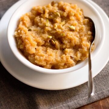 Moong dal halwa served in a bowl with a steel spoon