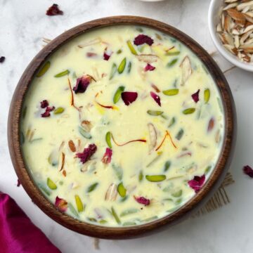 Paneer (Indian cottage cheese) kheer served in a wooden bowl with chopped almonds on the side