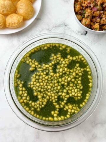 puri, potato mixture and pani on the table