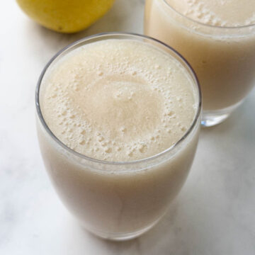 pear juice served in 2 glasses with pear on the side