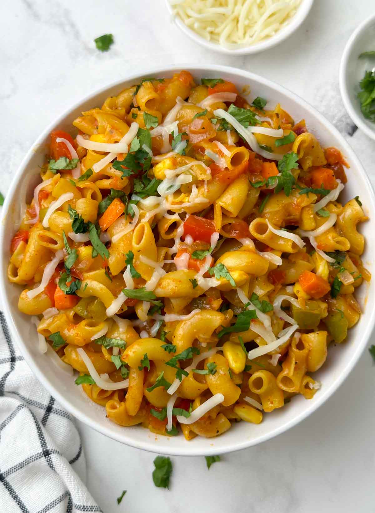 masala macaroni pasta served in a bowl garnished with cheese
