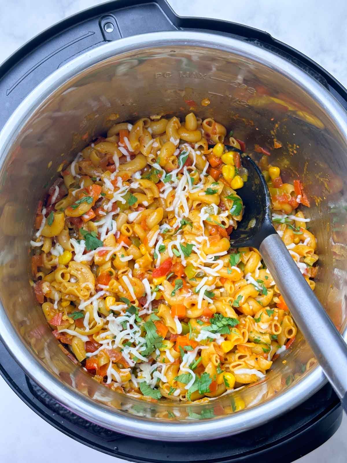 masala pasta in the instant pot with a ladle