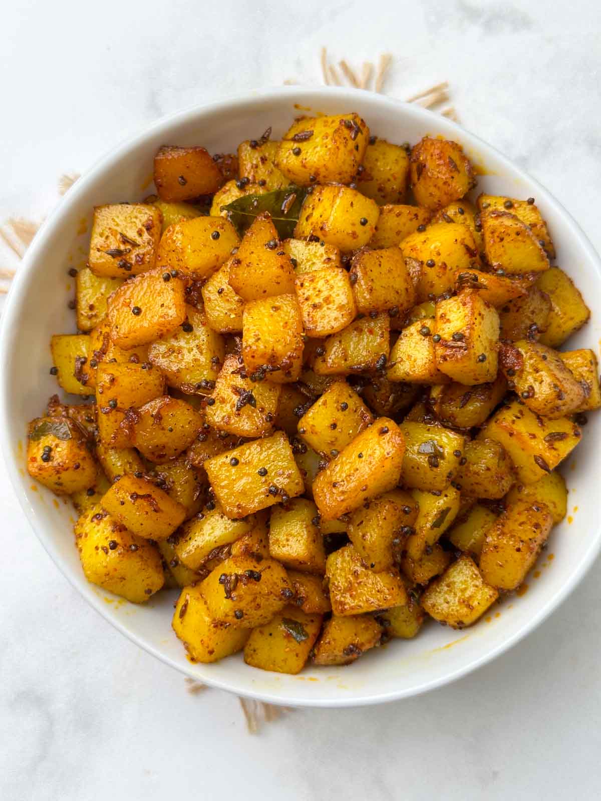 south indian potato fry served in a bowl