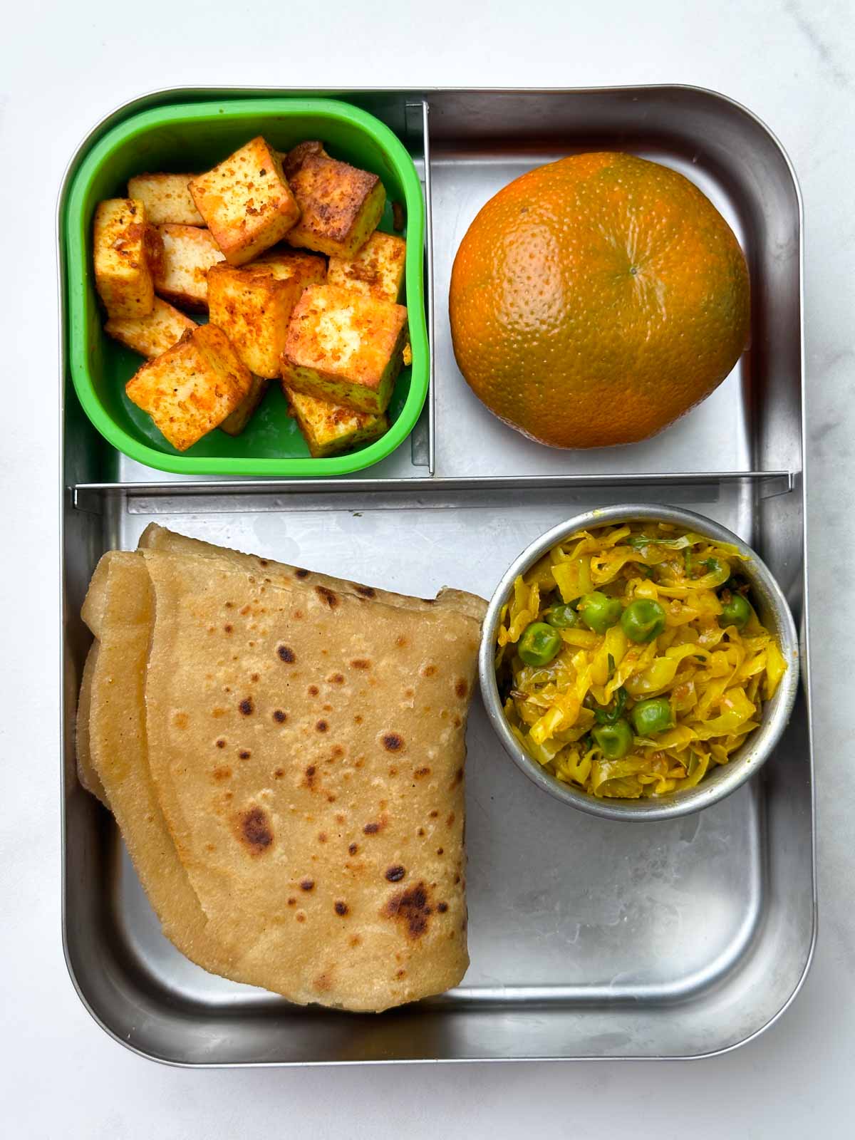 Paratha with cabbage peas stir fry, orange and masala paneer in the bento steel box