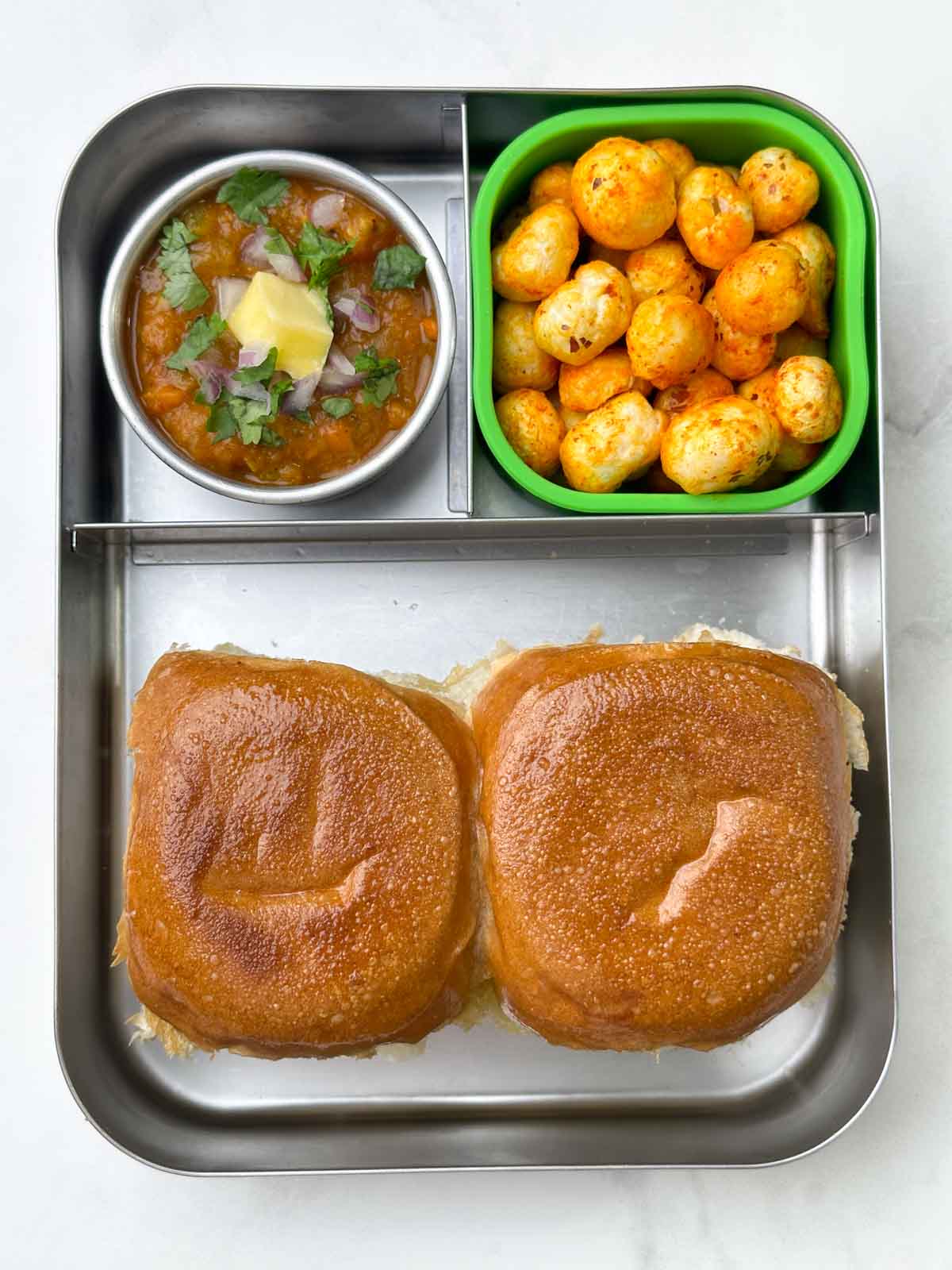 Pav bhaji and spicy masala makhana in bento steel box