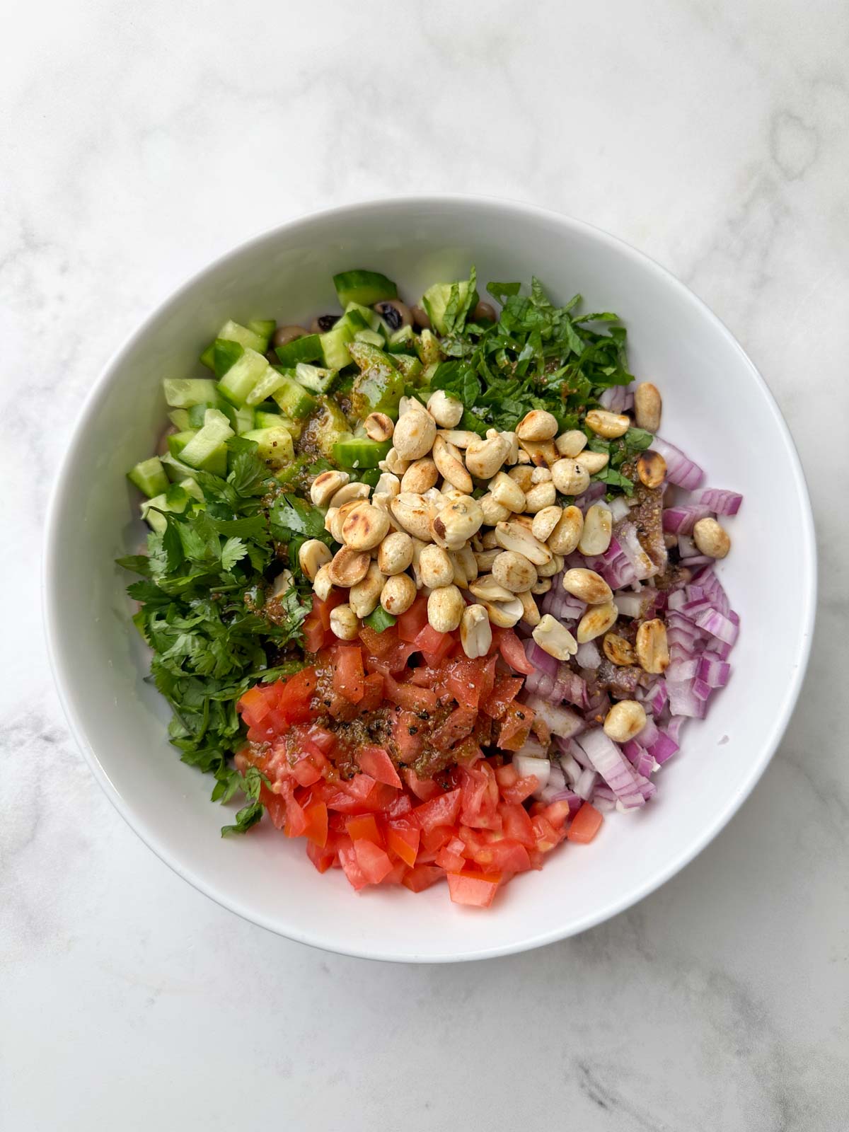 step to add all the salad ingredients to a bowl