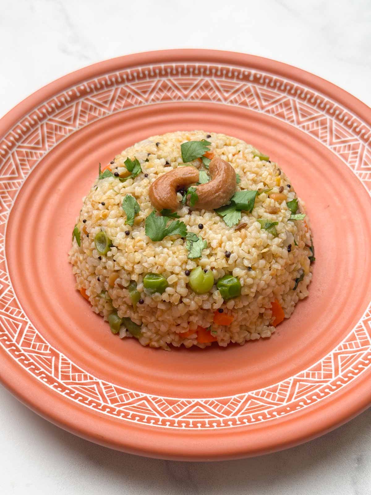 broken wheat upma served on a plate