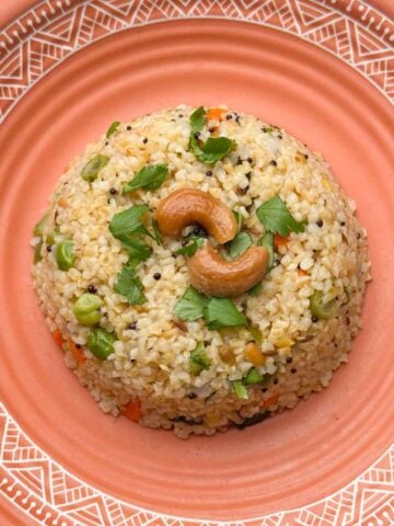 dalia upma (broken wheat upma) recipe served in a plate