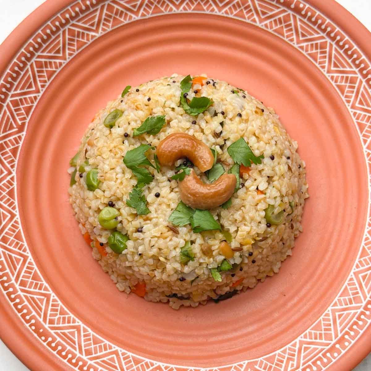 dalia upma (broken wheat upma) recipe served in a plate