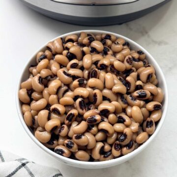 black eyed peas in a bowl with instant pot behind