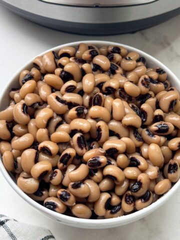 black eyed peas in a bowl with instant pot behind