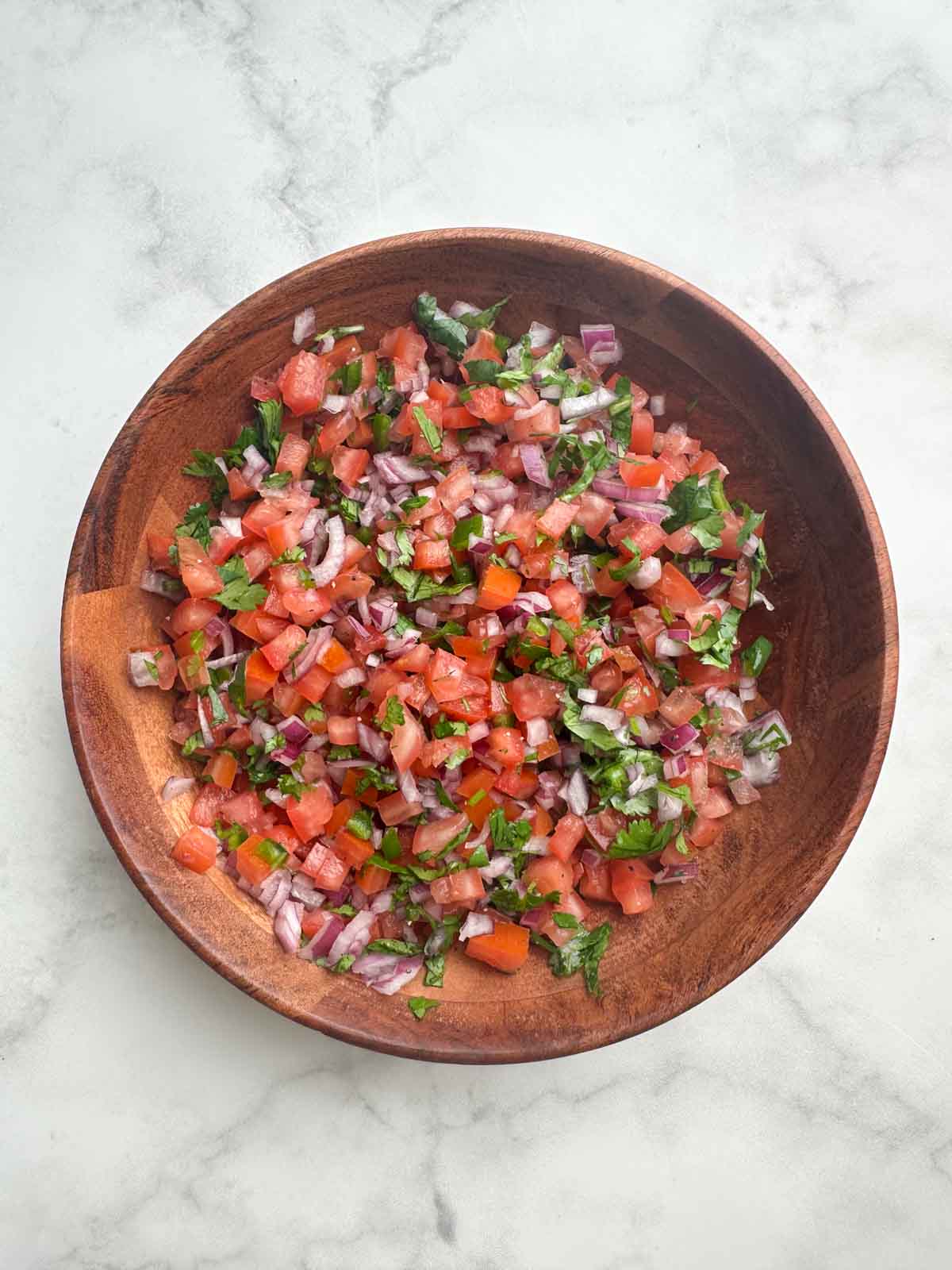 authentic pico de gallo dip in a wooden bowl