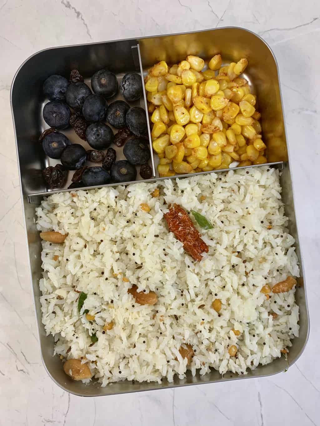 coconut rice with sweet corn and blueberries in bento steel lunch box