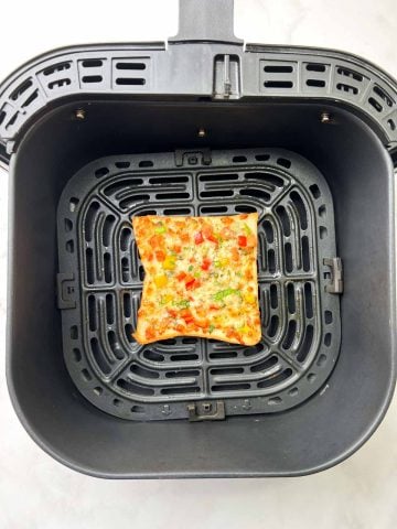 Perfectly air fried chili cheese toast in the air fryer basket.