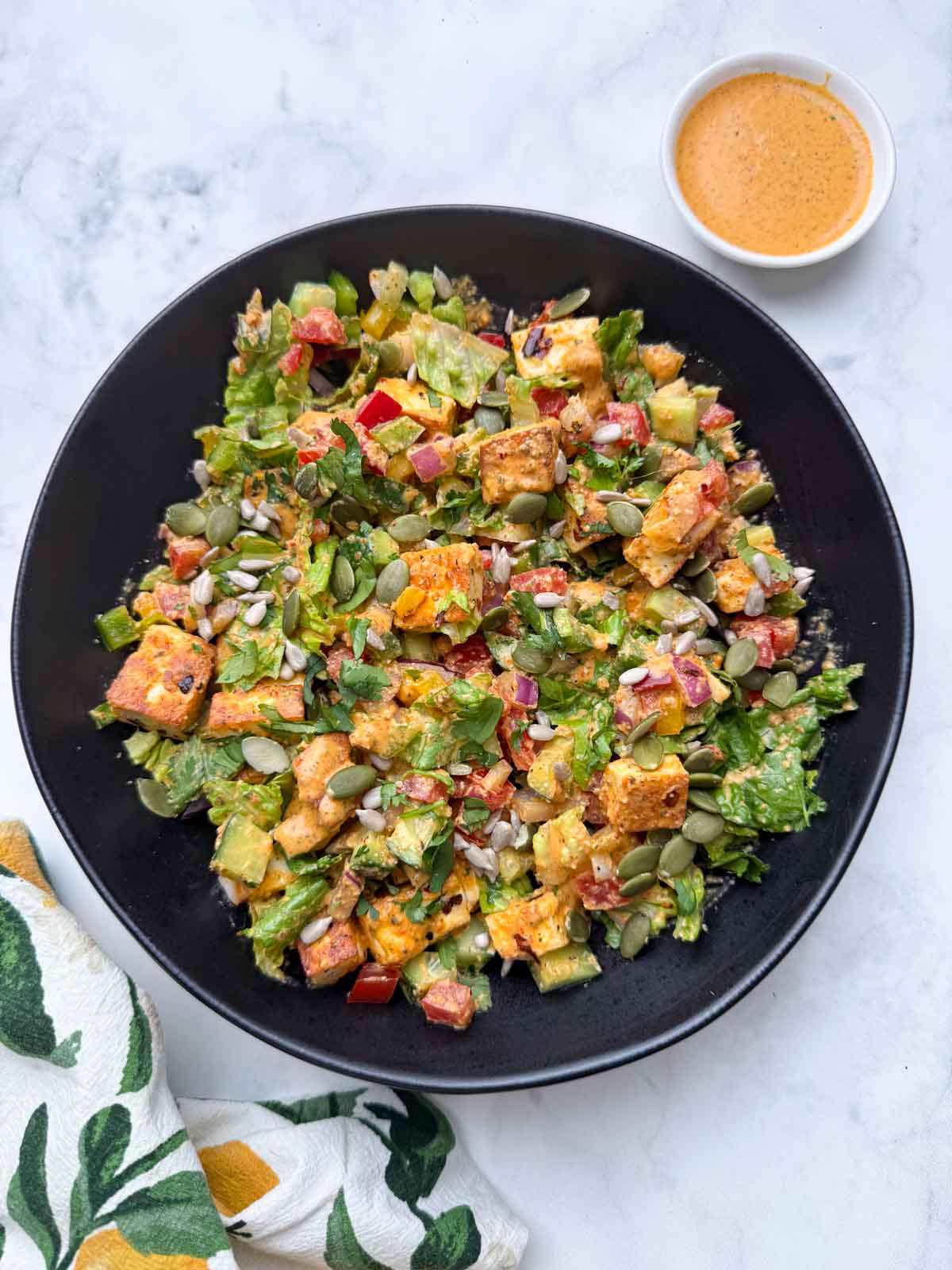 High protein paneer salad indian style served on a bowl with yogurt dressing on the side.