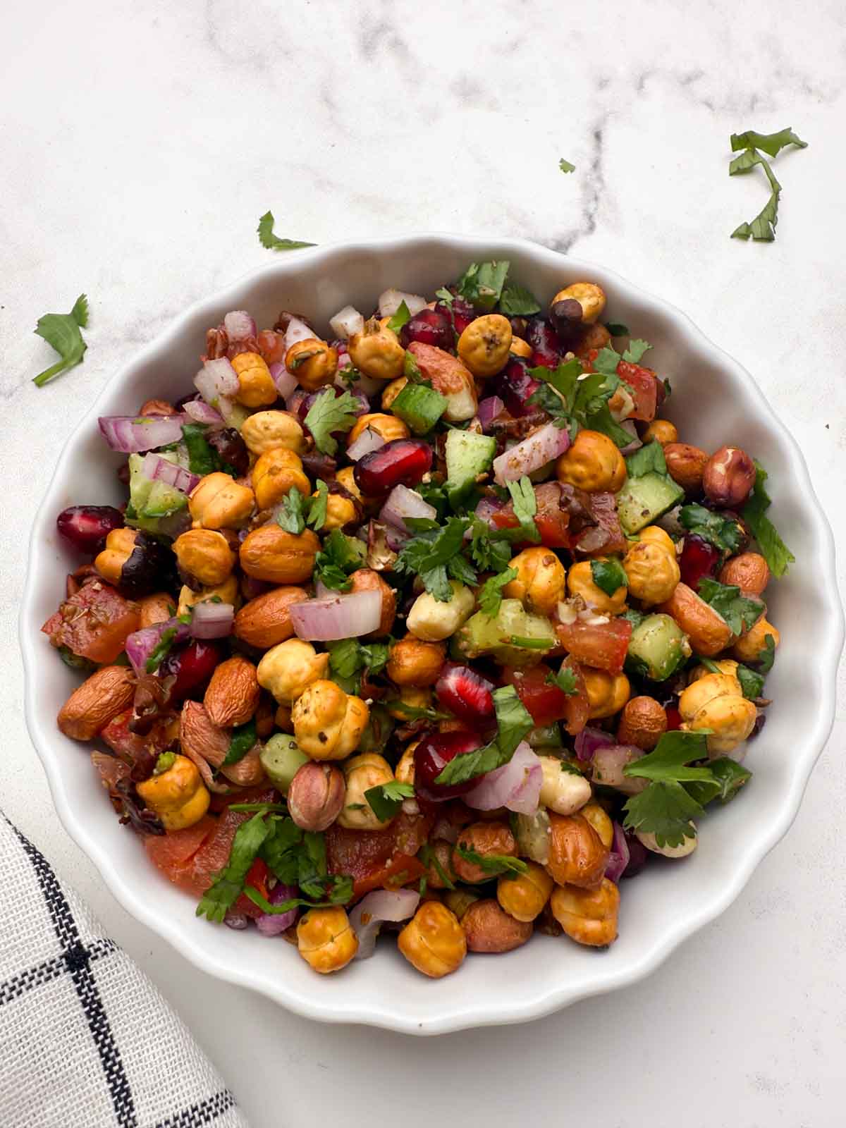 roasted chana salad served in a white bowl.