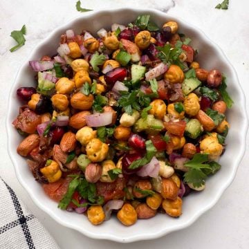 roasted chana salad served in a white bowl.
