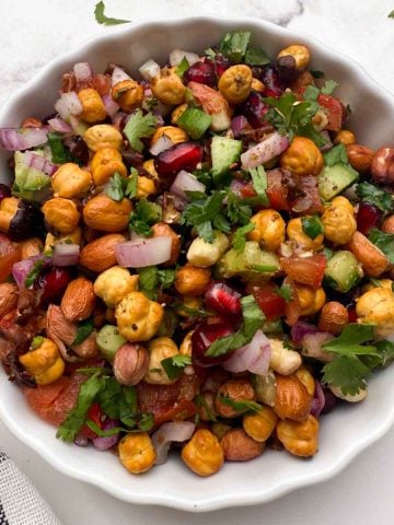 roasted chana salad served in a white bowl.