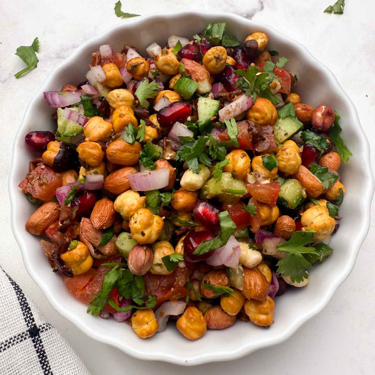 roasted chana salad served in a white bowl.