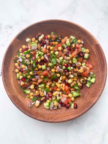 gently mixed salad in the wooden bowl.
