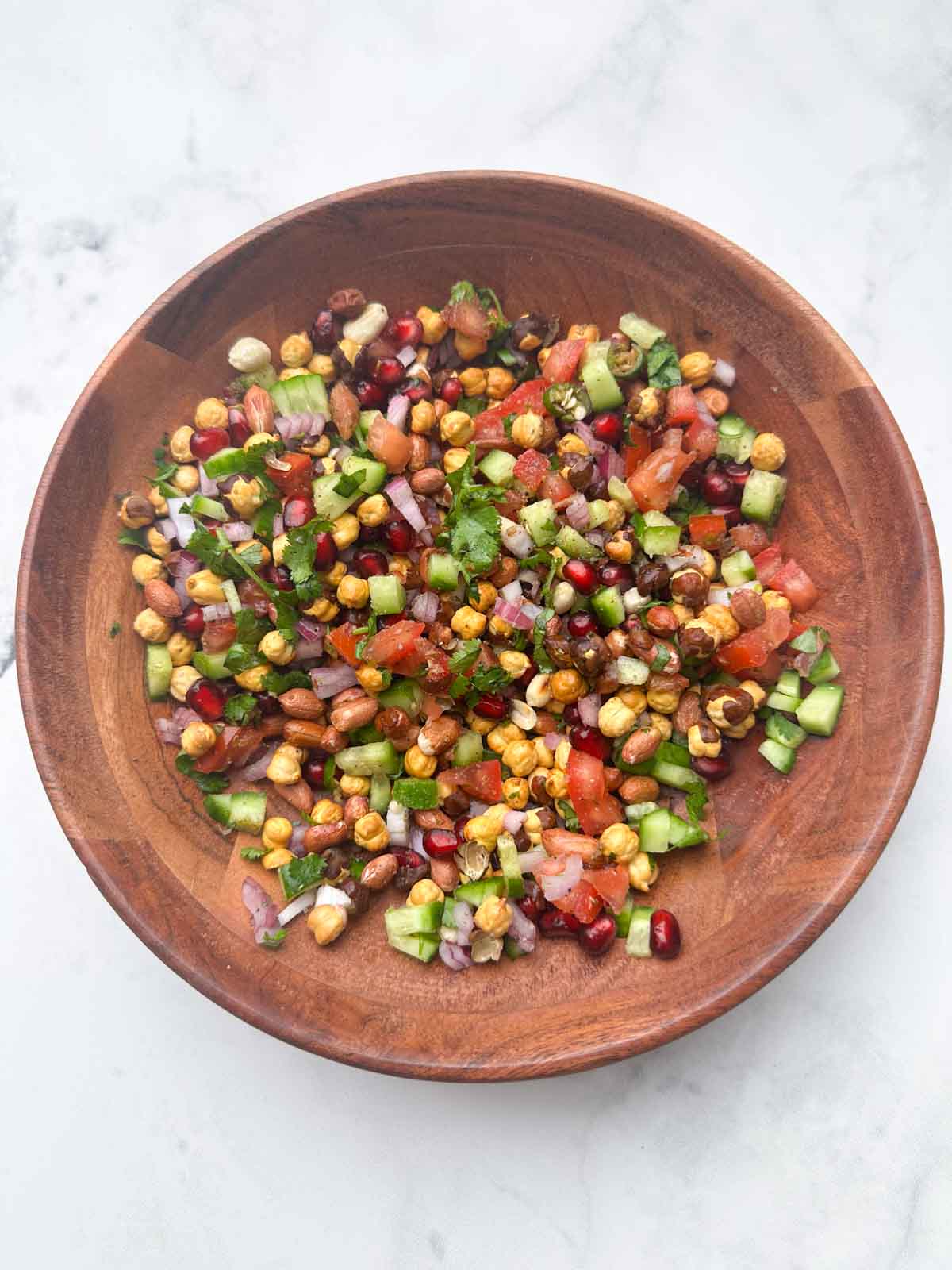 gently mixed salad in the wooden bowl.