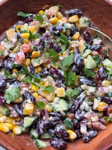 Indian rajma salad in a wooden bowl with a spoon on it.